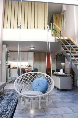 a swing in a living room with a staircase at New house in Piraeus in Piraeus