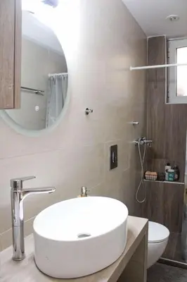 a bathroom with a white sink and a mirror at New house in Piraeus in Piraeus