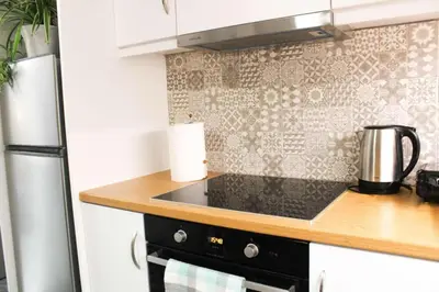 a kitchen with a stove top oven next to a refrigerator at New house in Piraeus in Piraeus
