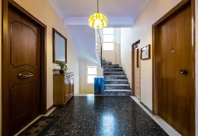 a hallway with a staircase and a door and a stair case at YOUR BRAND NEW Awesome Acropolis Home in Athens