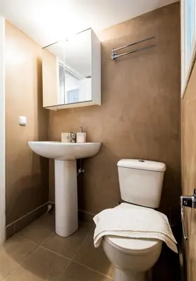 a bathroom with a toilet and a sink and a mirror at YOUR BRAND NEW Awesome Acropolis Home in Athens