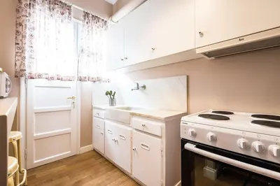 a white kitchen with a stove and a sink at YOUR BRAND NEW Awesome Acropolis Home in Athens