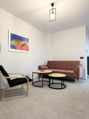 a living room with a couch and two tables at Cozy Apartment with Acropolis View Rooftop Access in Athens