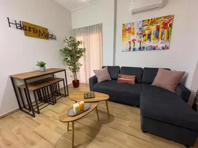 a living room with a blue couch and a table at Koukaki Athens Cozy Home in Athens