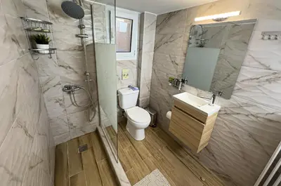 a bathroom with a toilet and a shower and a sink at Koukaki Athens Cozy Home in Athens