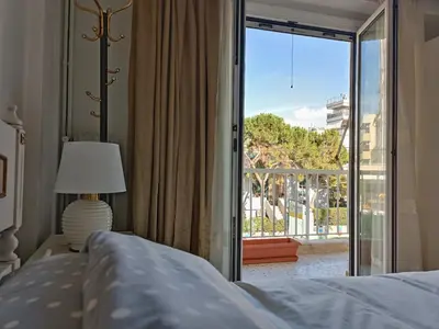 a bedroom with a bed and a view of a balcony at Aneto Edem in Athens