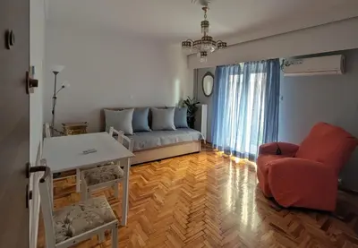 a living room with a couch and a table at Aneto Edem in Athens