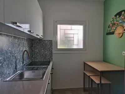 a kitchen with a sink and a window at Aneto Edem in Athens