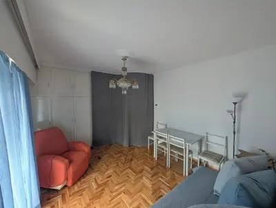 a living room with a couch and a table at Aneto Edem in Athens