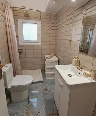 a bathroom with a toilet and a sink at Aneto Edem in Athens