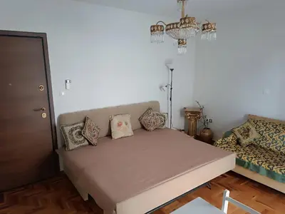 a living room with a couch and a chandelier at Aneto Edem in Athens