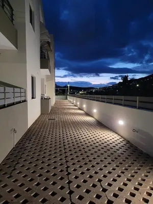 a balcony with lights on the side of a building at Ein Appartement zum wohlfühlen in Anavissos