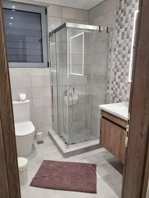 a bathroom with a shower and a toilet and a sink at Ein Appartement zum wohlfühlen in Anavissos