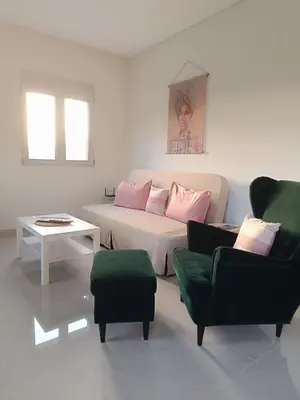 a living room with a couch and two chairs at Ein Appartement zum wohlfühlen in Anavissos