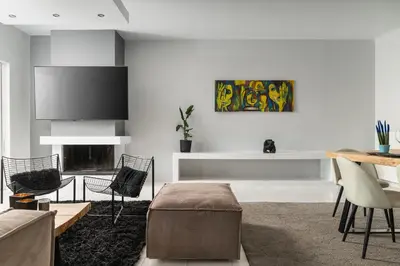 a living room with a table and a fireplace at Downtown Glyfada Riviera Eclipse in Athens