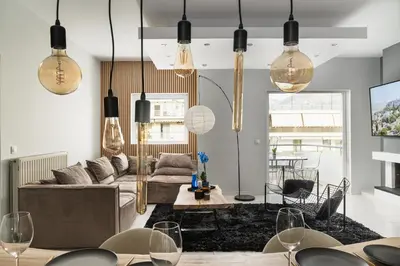 a living room with a couch and a table at Downtown Glyfada Riviera Eclipse in Athens
