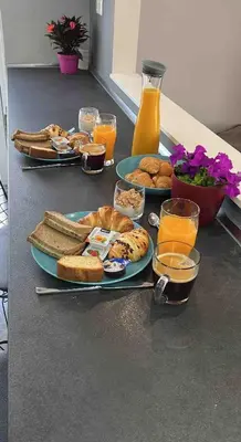 a table topped with plates of bread and orange juice at Downtown Glyfada Riviera Eclipse in Athens
