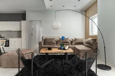 a living room with a couch and a table at Downtown Glyfada Riviera Eclipse in Athens