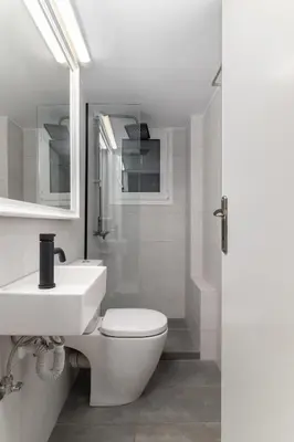 a bathroom with a toilet and a sink and a shower at Downtown Glyfada Riviera Eclipse in Athens