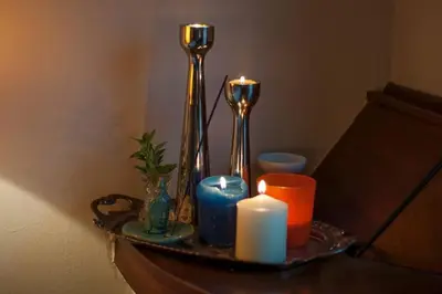 a tray with a candle and two silver vases and candles at Anafiotika FOS Cycladic Home! in Athens