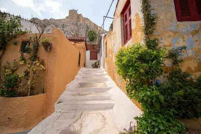 an alley with stairs leading up to a building at Anafiotika FOS Cycladic Home! in Athens