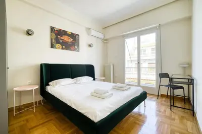 a bedroom with a bed with two towels on it at Spacious 3 Bedroom Flat at Metro in Athens