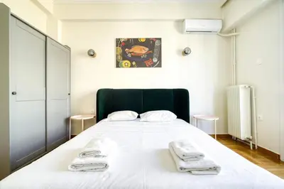 a bedroom with a large white bed with towels on it at Spacious 3 Bedroom Flat at Metro in Athens