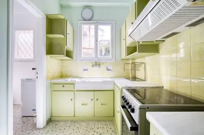 a kitchen with green cabinets and a sink at Spacious 3 Bedroom Flat at Metro in Athens