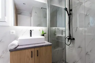 a bathroom with a sink and a shower at Bohemian Chic in the Heart of Athens in Athens
