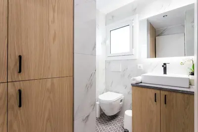 a white bathroom with a sink and a toilet at Bohemian Chic in the Heart of Athens in Athens
