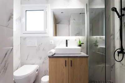 a bathroom with a sink and a toilet and a shower at Bohemian Chic in the Heart of Athens in Athens