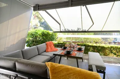 a living room with a couch and a table at Athenian Riviera Prestige 2 bedroom in Athens