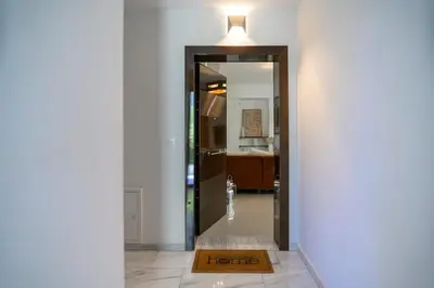 a hallway with a mirror and a light on top at Athenian Riviera Prestige 2 bedroom in Athens