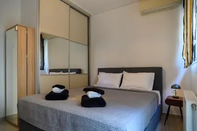 a bedroom with a bed with two towels on it at Athenian Riviera Prestige 2 bedroom in Athens