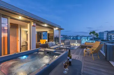 a hot tub on the balcony of a house at Acropolis View Luxe Penthouse with Outdoor Terrace HotTub in Athens
