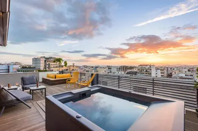 a hot tub on a balcony with a view of a city at Acropolis View Luxe Penthouse with Outdoor Terrace HotTub in Athens