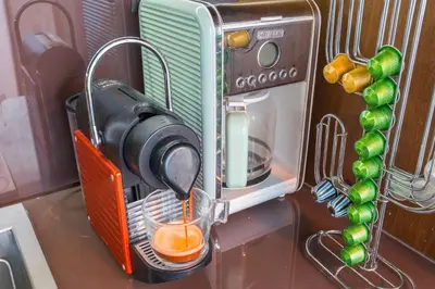 a juicer in a kitchen with a drink in a cup at Acropolis View Luxe Penthouse with Outdoor Terrace HotTub in Athens