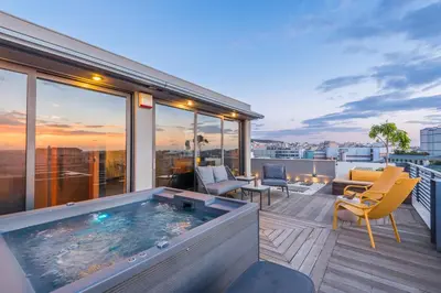 a balcony with a hot tub on top of a building at Acropolis View Luxe Penthouse with Outdoor Terrace HotTub in Athens