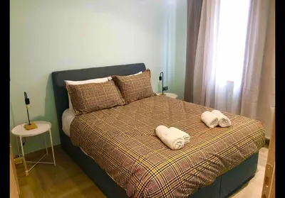 a bedroom with a bed with two towels on it at Agatha-1 in Piraeus