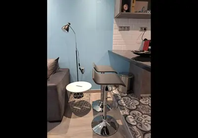 a kitchen with a stool and a lamp in a room at Agatha-1 in Piraeus
