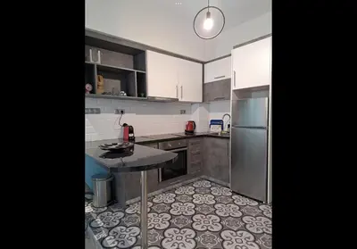 a kitchen with stainless steel appliances and a tile floor at Agatha-1 in Piraeus