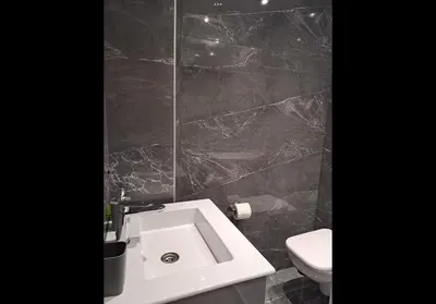a bathroom with a white sink and a toilet at Agatha-1 in Piraeus