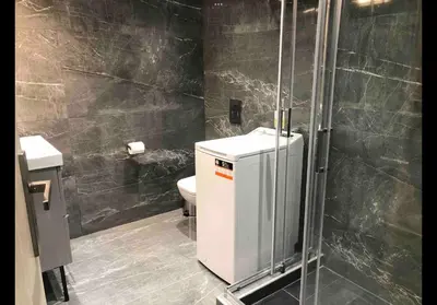 a bathroom with a toilet and a glass shower at Agatha-2 in Piraeus