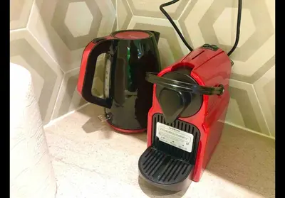 a red suitcase sitting next to a blender at Agatha-2 in Piraeus