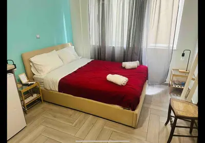 a bedroom with a bed with two towels on it at Agatha-3 in Piraeus