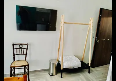 a room with a swing and a chair and a tv at Agatha-3 in Piraeus