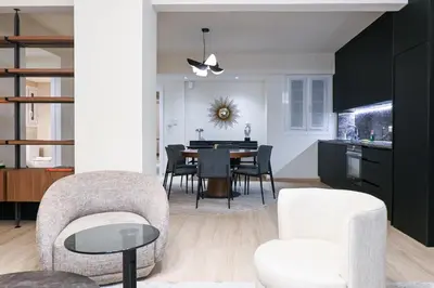 a kitchen and dining room with a table and chairs at Sophisticated Living ,Balcony & Stunning Interior in Athens