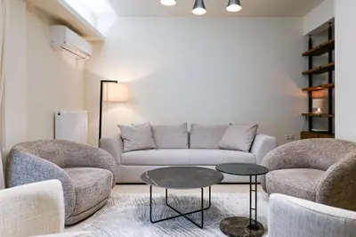 a living room with a couch and two chairs and a table at Sophisticated Living ,Balcony & Stunning Interior in Athens