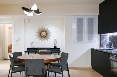 a kitchen and dining room with a table and chairs at Sophisticated Living ,Balcony & Stunning Interior in Athens