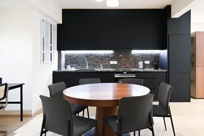 a dining room with a wooden table and chairs at Sophisticated Living ,Balcony & Stunning Interior in Athens